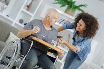 woman caregiver assisting the elderly man